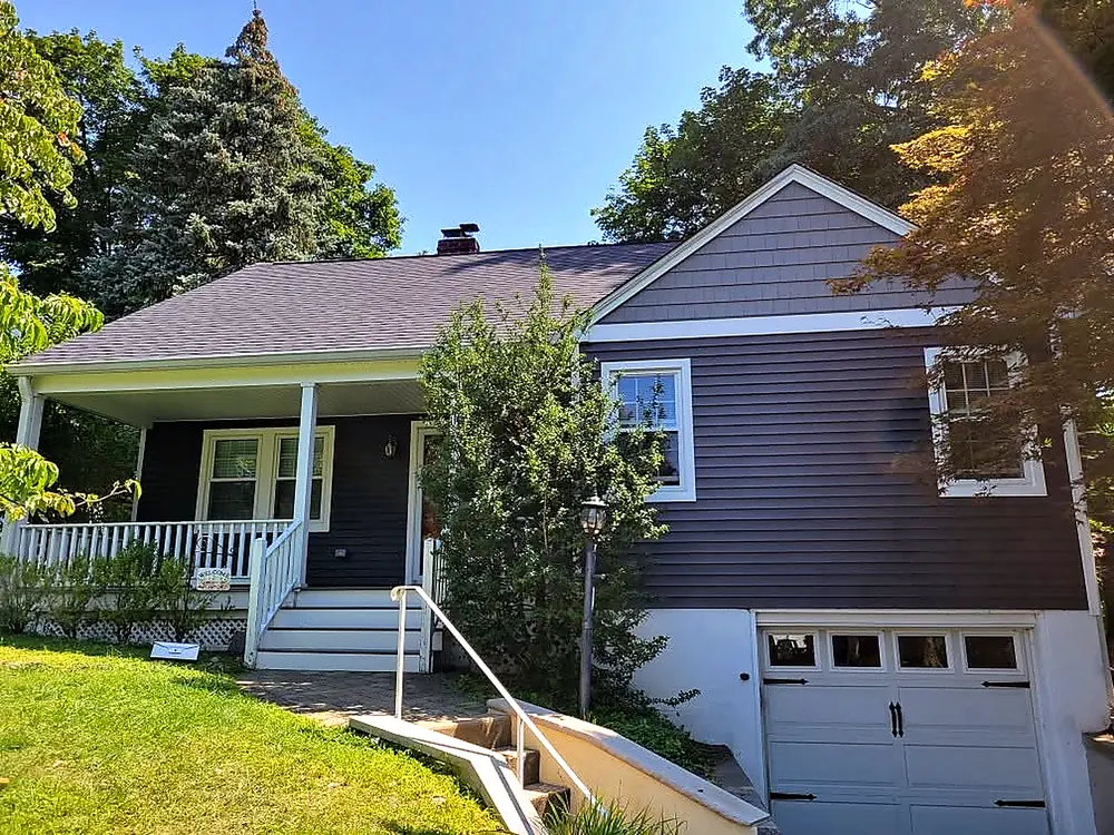 Cape Cod house after a full siding and roofing replacement