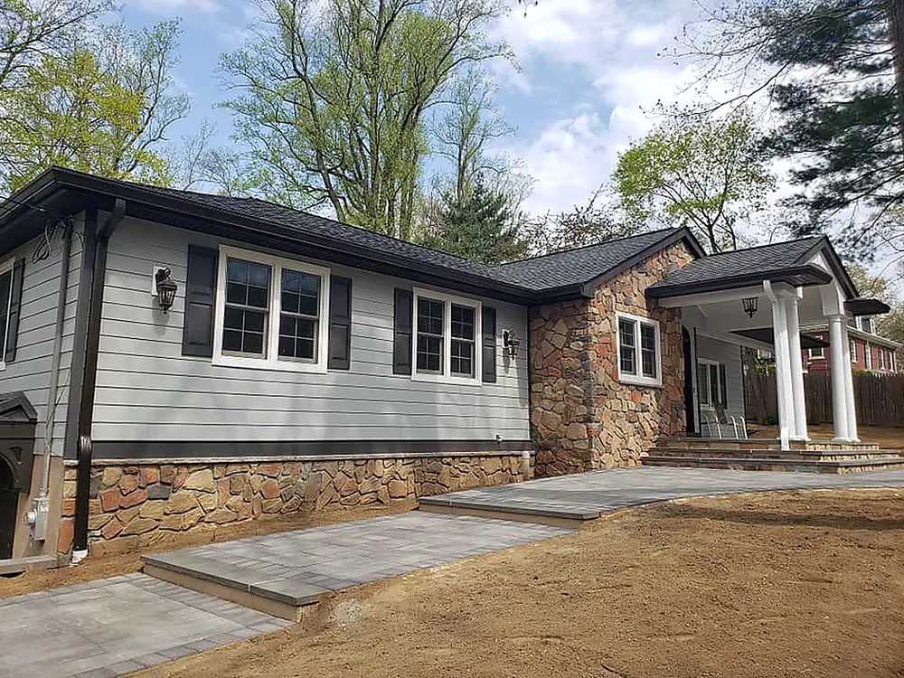 Ranch home with new gray siding, stone accents and a new roof