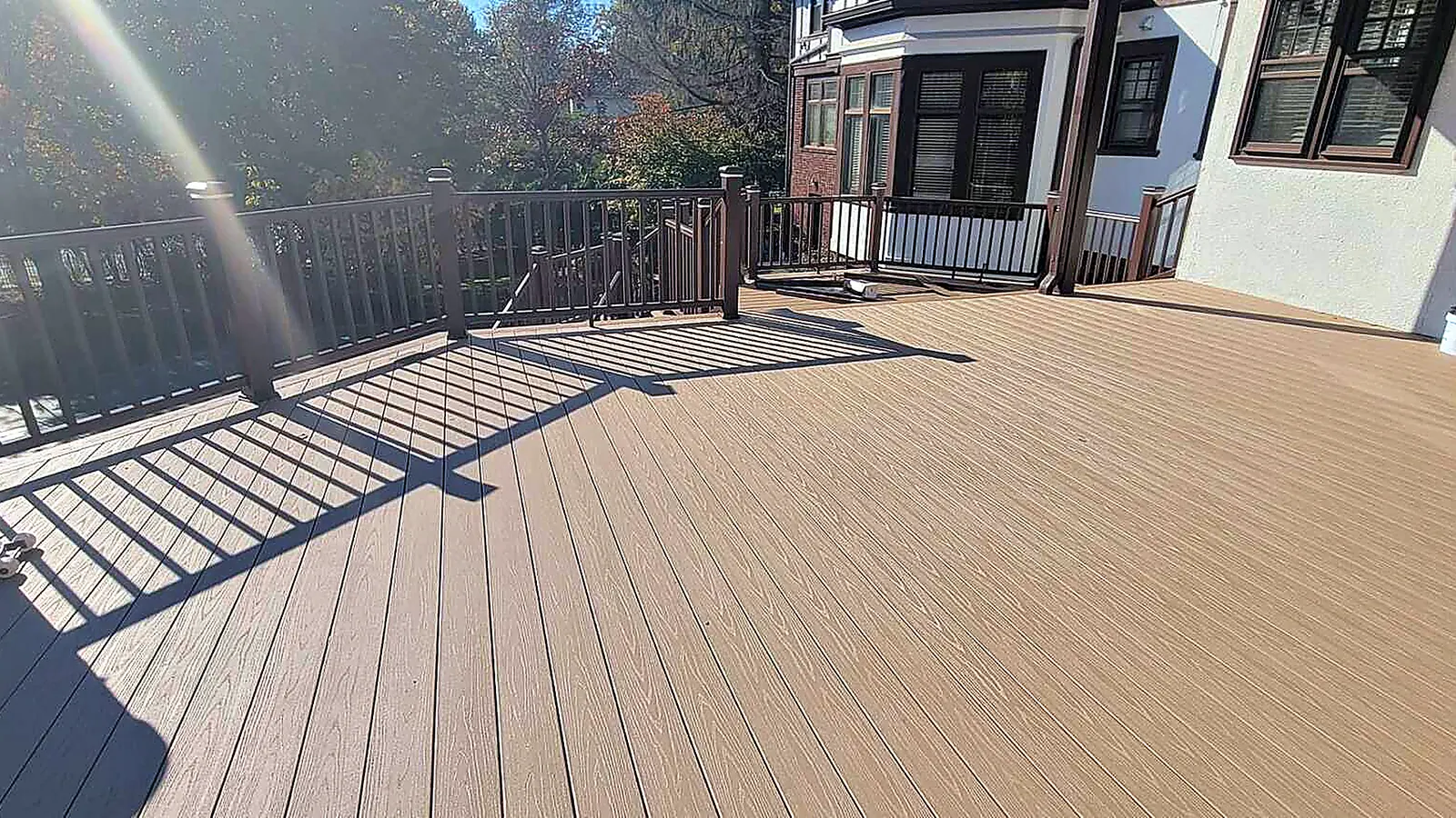 Composite deck with dark railings built by RJ Construction