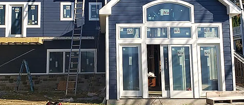 New French doors and windows on a navy-sided addition, work by RJ Construction